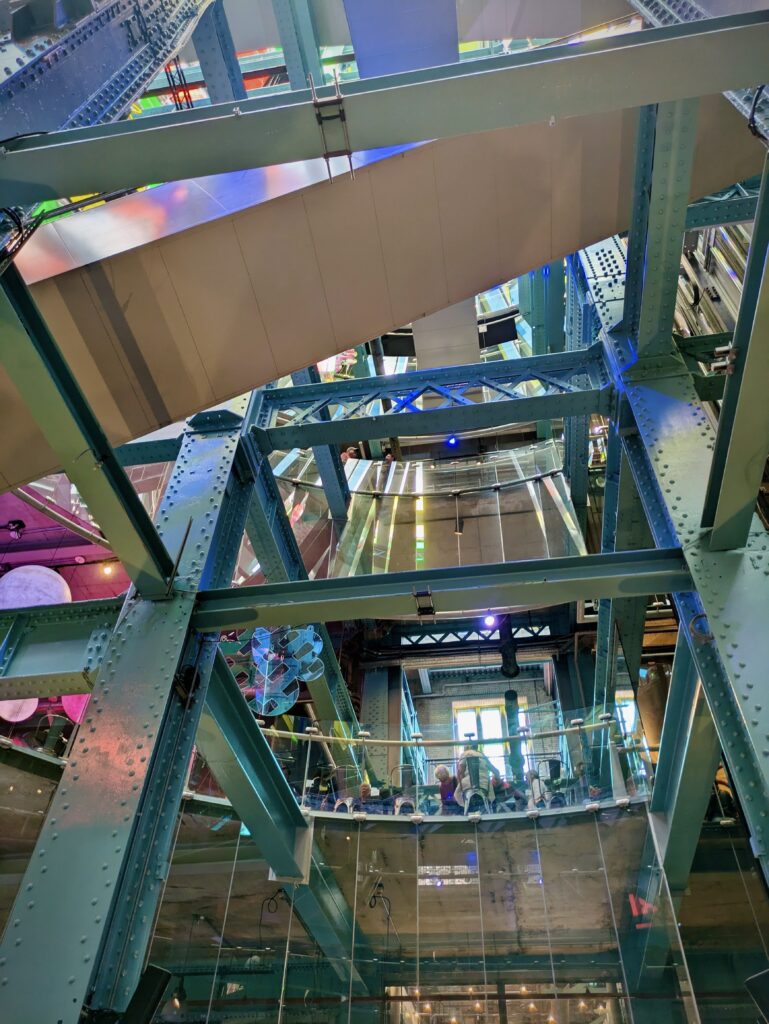 bright and colorfully illuminated view looking up at multiple floors of the storehouse upon entry